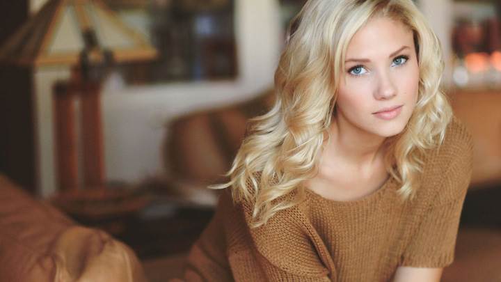 Berit Birkeland Sitting Pose In Brown Woolen Dress